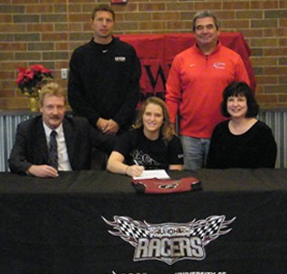 Ellie Comes (center) signed to play volleyball at UNOH. She set the career digs record while at Owens C.C.